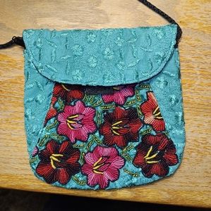 Small sky blue purse with red and Pink embroidered flowers